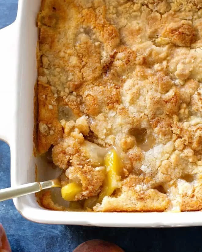 Delicious easy peach cobbler topped with ice cream